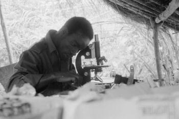 | A student uses a microscope during a PAIGC medical consultation in a college in Campada 1973 Source Roel Coutinho Guinea Bissau and Senegal Photographs 19731974 | MR Online