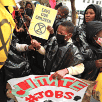 | Protesters carry placards as they demonstrate as part of a global day of action on climate change outside parliament in Cape Town South Africa September 25 2020 Mike HutchingsReuters | MR Online