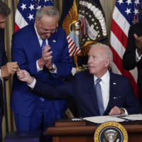 President Joe Biden hands the pen he used to sign the Inflation Reduction Act to Sen. Joe Manchin on Aug. 16, 2022. (AP Photo/Susan Walsh)