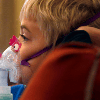 A child receives asthma treatment in his home. (AP Photo/Charles Rex Arbogast)