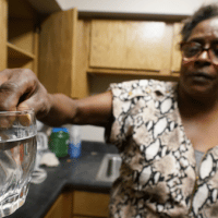 | A resident displays contaminated water in her kitchen in Jackson Miss AP PhotoSteve Helber | MR Online