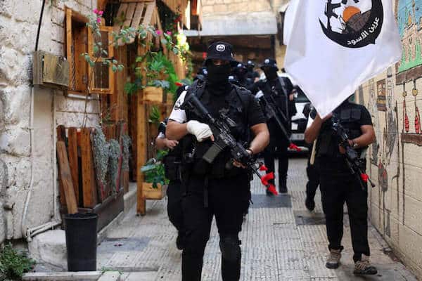 | MEMBERS OF THE LIONS DEN HOLD THEIR WEAPONS NEXT TO A FLAG FLYING THE LIONS DEN LOGO DURING A MEMORIAL SERVICE OF MOHAMMED AL AZIZI AND ABDUL RAHMAN SOBH WHO WERE KILLED BY ISRAELI FORCES IN THE WEST BANK CITY OF NABLUS ON SEPTEMBER 2 2022 PHOTO SHADI JARARAH APA IMAGES | MR Online