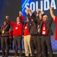 | Newly elected UAW leaders including Secretary Treasurer Margaret Mock third from left and President Shawn Fain fourth from left at the convention on March 29 2023 Fain said The rumble of the election is finished and called on members to unite against the employers Photo Jim West jimwestphotocom | MR Online