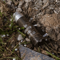 A cluster bomb capsule is seen on the ground amid the Russia-Ukraine war at the frontline city of Avdiivka, Ukraine on March 23, 2023. (Photo: Andre Luis Alves/Anadolu Agency via Getty Images/Common Dreams)