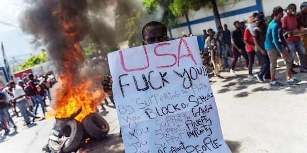 | Haitian protester holds an anti US sign during a protest against the unelected US backed Haitian regime in Port au Prince Haiti on Oct 17 2022 Photo Richard PierrinAFP | MR Online