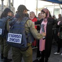 Palestinians pass through an Israeli checkpoint between Bethlehem and Jerusalem in the occupied West Bank. Photo: Getty images/File photo.