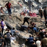 Palestinians work in the debris of buildings targeted by Israeli airstrikes in Jabalia refugee camp, northern Gaza, Nov 1, 2023