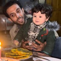 TAREQ HAJJAJ AND HIS SON QAIS ON HIS FIRST BIRTHDAY, IN AN ABANDONED HOME IN YIBNA REFUGEE CAMP, DECEMBER 2023. (PHOTO: TAREQ HAJJAJ)