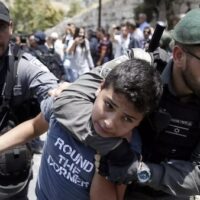 Israeli security forces detain a Palestinian youth during a demonstration outside al-Aqsa mosque in Jerusalem's Old City on 17 July 2017 (AFP)