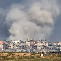 A smoke plume erupts during Israeli bombardment on the northern Gaza Strip near the border with southern Israel on 17 December 2023 (Jack Guez/AFP)