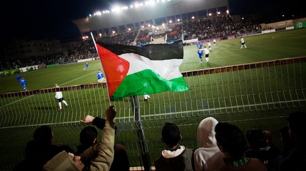 | Palestinian soccer supporters watch a match between the Palestinian team and Thailand in the West Bank town of Al Ram near Ramallah Bernat Armangue | AP | MR Online