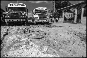 | Buses line up to take maquiladora workers from the Derechos Humanos and Fuerza y Unidad barrios in Matamoros to the factories where they work The neighborhoods are contaminated by the dumping of white powder chemical waste from the Quimica Fluor plant which makes hydrofluoric acid onto the dirt roads between the houses David Bacon | MR Online