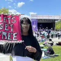 | Avis Lee holds a banner for Lets Get Free the Women and Trans Prisoner Defense Committee which helped with her fight for freedom and with which she now organizes to free others | MR Online