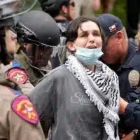 Texas state troopers and University of Texas Police detain a woman at a pro-Palestinian protest at the University of Texas on 24 April, 2024 (Reuters)