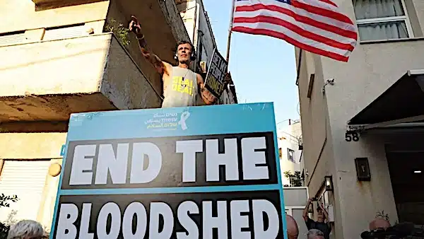 | A protester waves the US flag during a gathering calling for the release of Israeli hostages in Gaza in Tel Aviv on 19 August 2024 Jack GuezAFP | MR Online