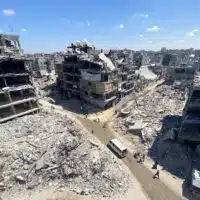 PEOPLE MAKE THEIR WAY AMID THE RUBBLE OF BUILDINGS DESTROYED DURING ISRAELI BOMBARDMENT OF THE THE JABALIA REFUGEE ON AUGUST 31, 2024. (PHOTO: HADI DAOUD / APA IMAGES)