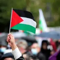 A demonstrator holds a Palestinian flag during a protest in support of Palestinians following a flare-up of Israeli-Palestinian violence, on Republique square in Paris, France, May 22, 2021. REUTERS/Benoit Tessier