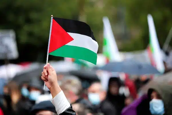 | A demonstrator holds a Palestinian flag during a protest in support of Palestinians following a flare up of Israeli Palestinian violence on Republique square in Paris France May 22 2021 REUTERSBenoit Tessier | MR Online