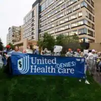 Health care advocates risk arrest protesting care denials at UnitedHealthcare on July 15, 2024, in Minnetonka, Minnesota. DAVID BERDING / GETTY IMAGES FOR PEOPLE'S ACTION INSTITUTE