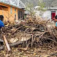 Residents collect garbage and debris to burn in the town of Acoua after Cyclone Chido wreaked havoc on the French island territory of Mayotte on December 25, 2024. (Photo: Patrick Meinhardt/AFP via Getty Images)