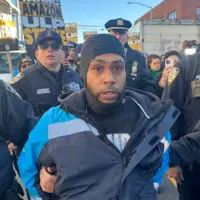 At the DBK4 delivery station in Queens, New York, cops swarmed and arrested an Amazon driver who stopped his van in support of the strike. Then they forcibly broke the picket line. Photo: Luis Feliz Leon